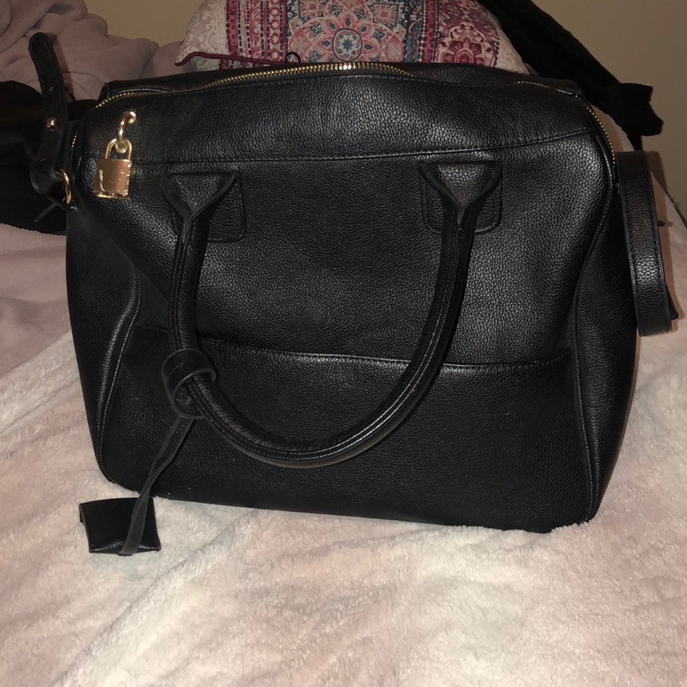 Black tote bag with gold detail.